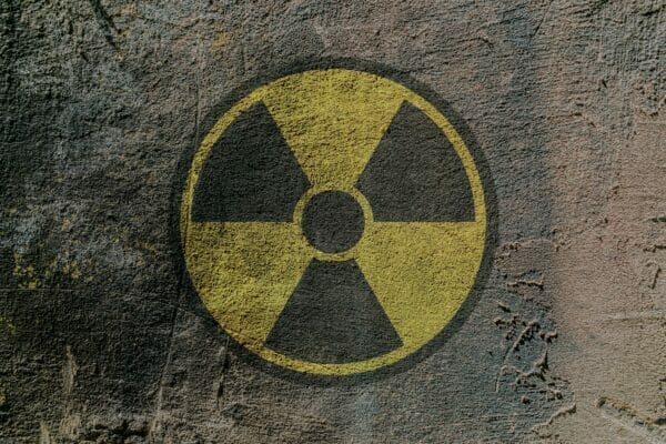 Sign of radioactive danger depicted on a concrete wall